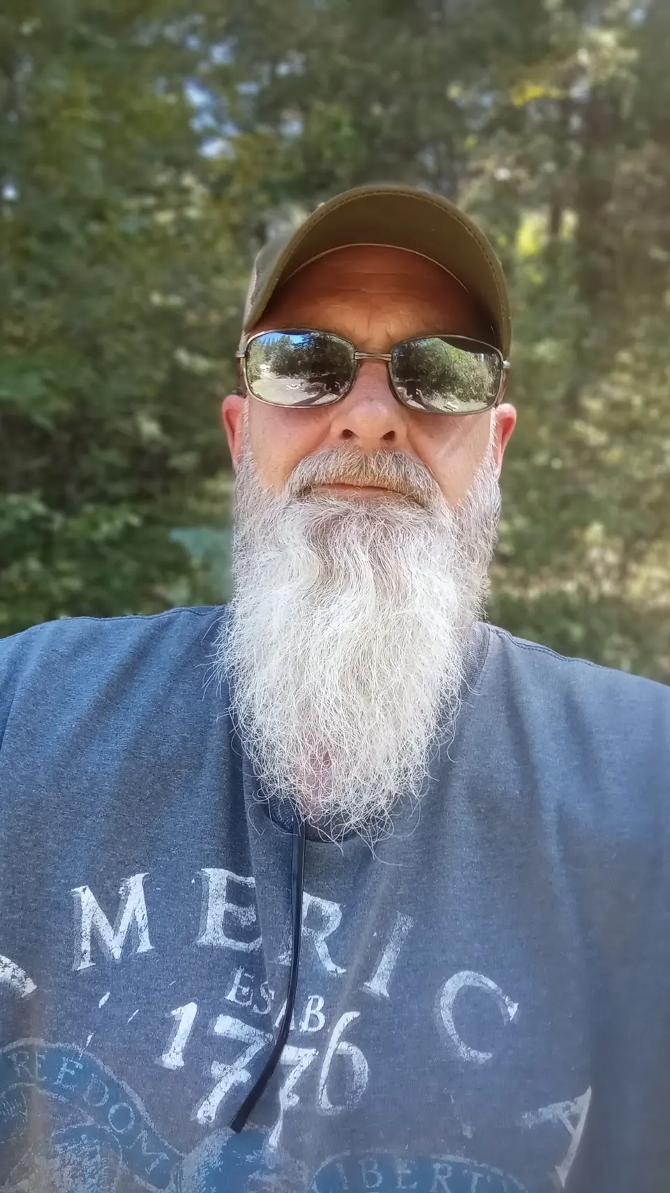 Chris Smith outdoors at a forest campsite